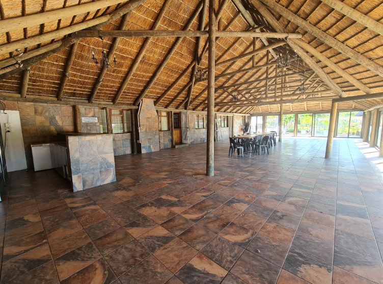 Inside the Parvulus thatched hall with tiled floor and bar