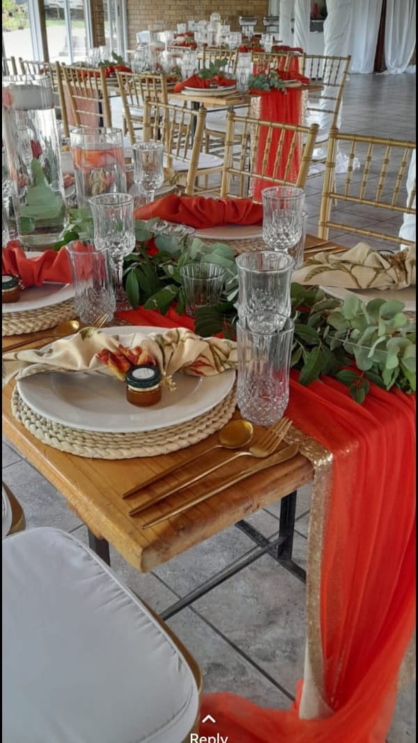 Long banquet table with red and gold runners
