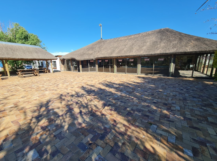 Parvulus thatched venue and paved courtyard